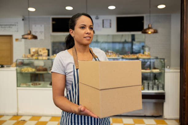istock Waitress carrying boxes with a delivery order at a cafe 1482940936