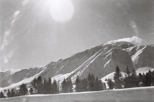 Landscape of Sun Beaming down on the snow covered Sierra Nevadas. Shot in 35mm Black and White 400 ISO