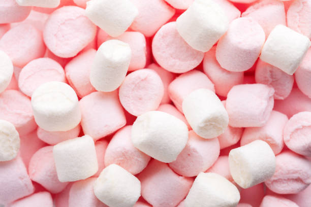 istock Mini marshmallows of white and light pink colors. Selective Focus. Flat lay. 1482941727