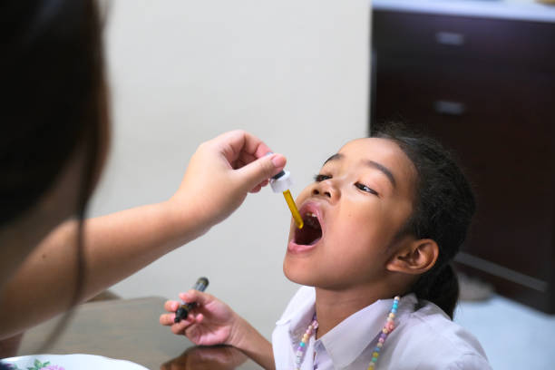 istock Asian little girl having drops medicine 1482944875