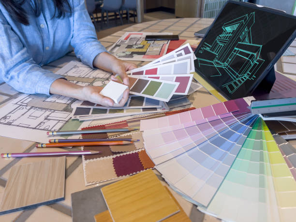 istock A female designer working with smart device and material sample at design studio. 1482951154