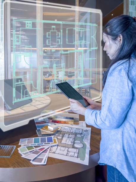 istock A female designer working with smart device & futuristic technology at design studio. 1482951156
