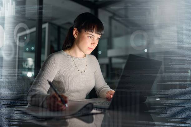 istock Businesswoman, laptop and writing analytics at night for planning, documents or online research at office. Female employee with computer in analysis, strategy or project plan on dark digital overlay 1482951251