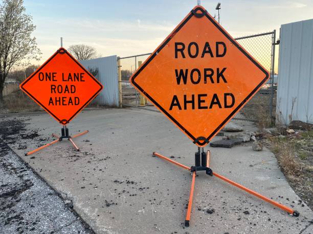 istock One lane road ahead and road work ahead signs 1482956379