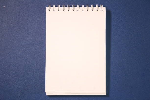 istock a Blank Paper on top of Blue Table 1482958668