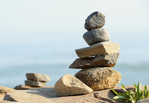 zen stones with a sea view behind