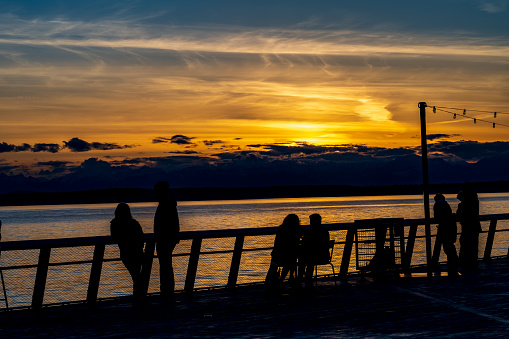 Seattle WA, USA - April 4, 2023:  People enjoy the sunset from Pier 62.