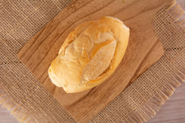 A stack of freshly baked artisan bread displayed at a stall.