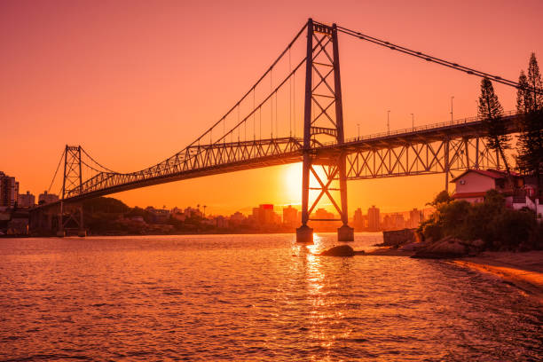 istock Hercilio luz old bridge with warm sunset and reflection on water in Florianopolis 1482966360