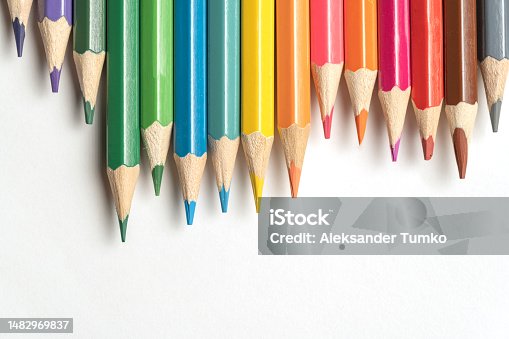 istock Colored pencils lie in a row. A line drawn with pencil tips. Set of crayons for illustrations, art, study. Ready for school. 1482969837