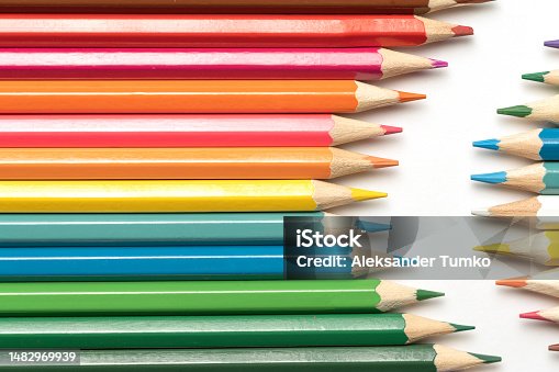 istock Colored pencils lie in a row. A line drawn with pencil tips. Set of crayons for illustrations, art, study. Ready for school. 1482969939