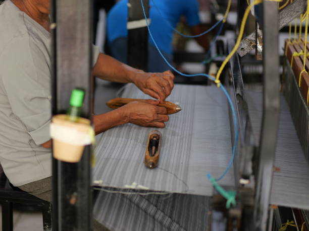 istock Selective focus traditional weaver is preparing yarn. Preparing the loom before starting to make woven ikat 1482970989
