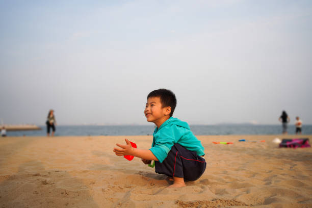 Baby's foot in the sand stock photo