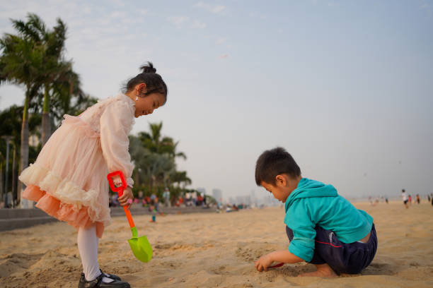 Happy children kid enjoy and fun outdoor lifestyle travel nature at the sea on summer beach holiday vacation. Portrait of Little cute child boy in swimwear relaxing on the beach in summer sunny day.