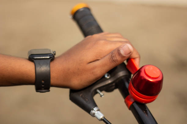istock A hand holds a bicycle handle and a watch his hand 1482972032