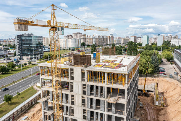istock construction site with yellow crane against blue sky. new office building under construction. aerial view. 1482973016