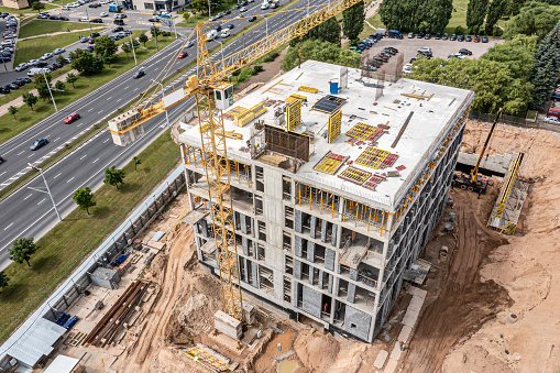 new office building under construction. aerial view of construction site on sunny summer day.