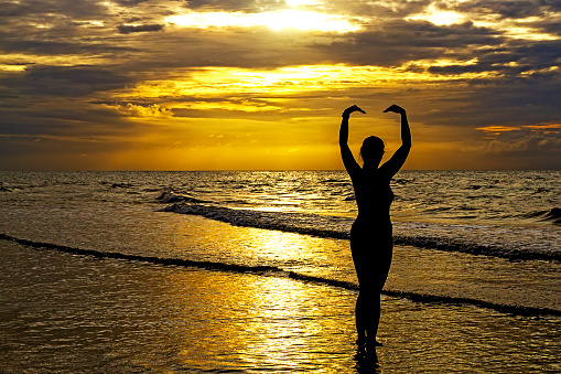 Woman with swimsuit relax with silhouette at beach Hat Wanakon National Park, Prachuap Khiri Khan Province in Thailand is famous for travel and relax