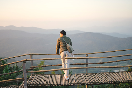 Asian traveller looking at Sunrise  Doi- mon jam chiang mai nature landscape scenic misty mountain and forest  at the north Thailand