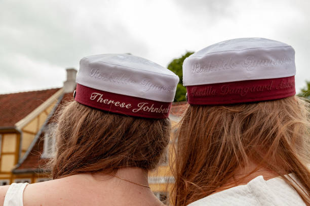 Graduation and summer holidays celebrations, traditions, culture and revelry with hats embroidered with graduating students names Roskilde Denmark June 26 2015: Graduation and summer holidays celebrations, traditions, culture and revelry with hats, nude swims in Roskilde Fijord and party trucks driving through the city danish culture stock pictures, royalty-free photos & images