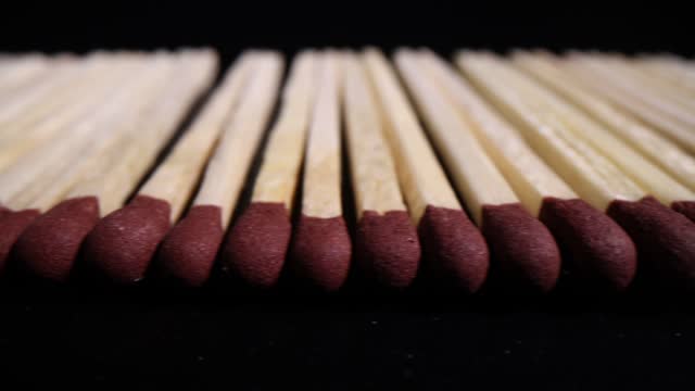 Wooden matches with brown black head on black background