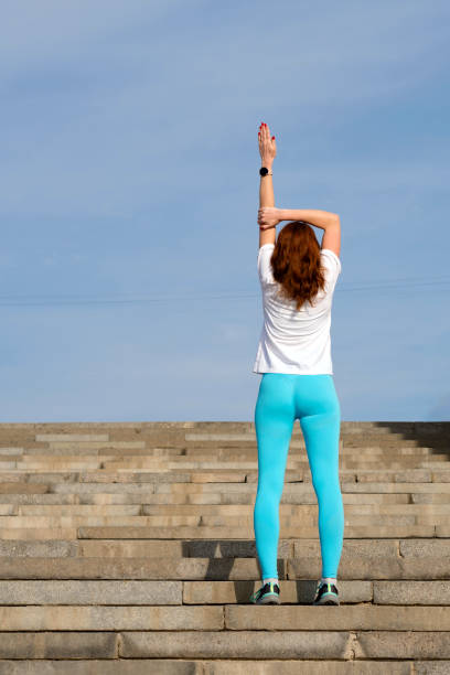 istock Woman doing warm up before workout on street 1482986181