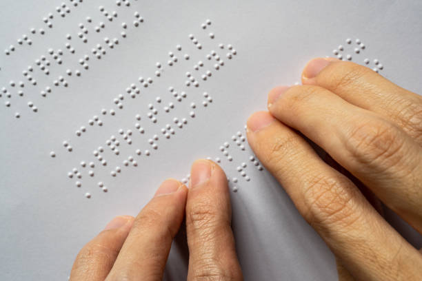 Blind person reading braille of alphabet A to Z stock photo