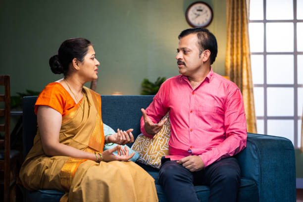 Wife got angry while arguing with husband at home - concept of relationship problems, conflict and unhappy relationship. Wife got angry while arguing with husband at home - concept of relationship problems, conflict and unhappy relationship divorce india stock pictures, royalty-free photos & images