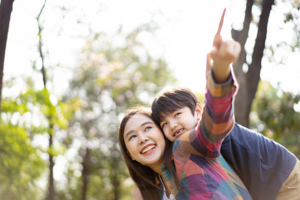 istock Mother and son playing together at the park. 1482987712