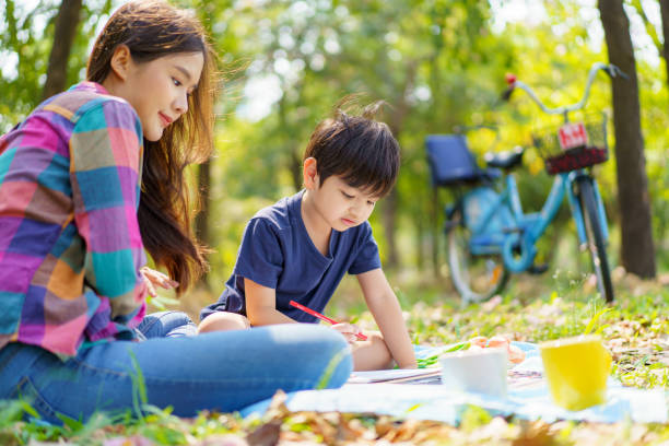 istock Mother and son relaxing at the park. 1482988318