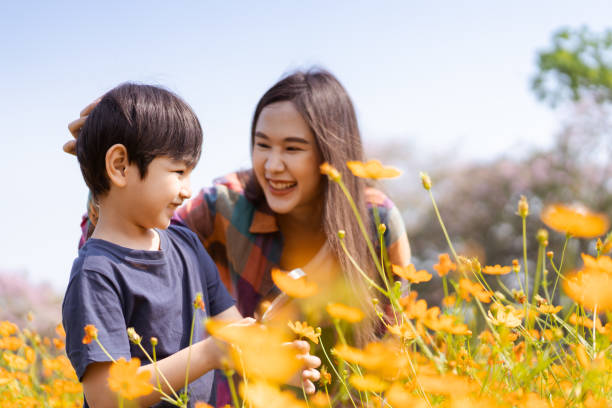 istock Boy playing in meadow with mom field. 1482989301