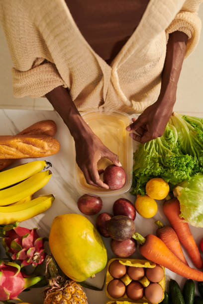 istock Woman Packing Groceries in Containers 1482990600