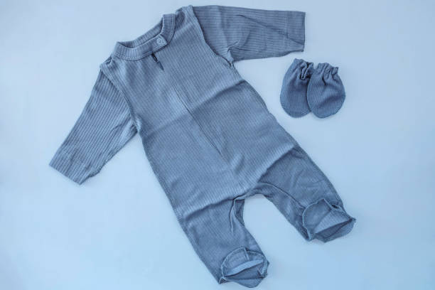 istock Jumpsuit and booties for a newborn boy lying on a blue background 1482992360