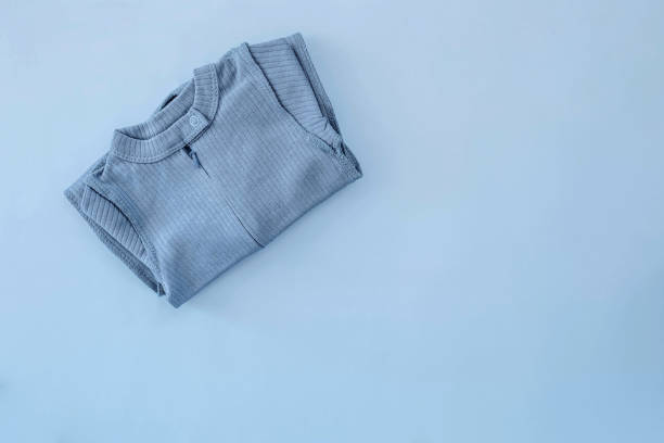 istock Jumpsuit for a newborn boy lying on a blue background 1482992498