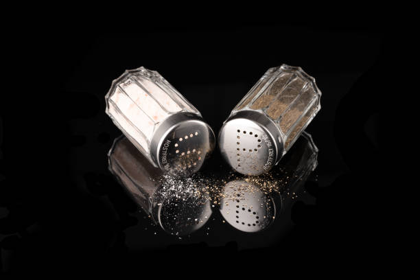 Salt and pepper shaker isolated on black background