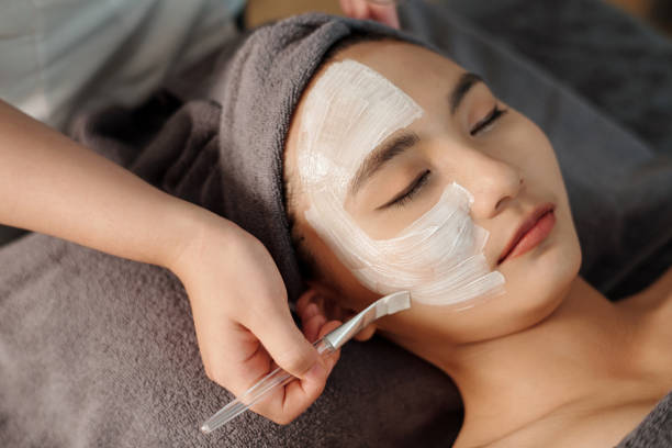 istock Esthetician Applying White Clay Mask 1482994167