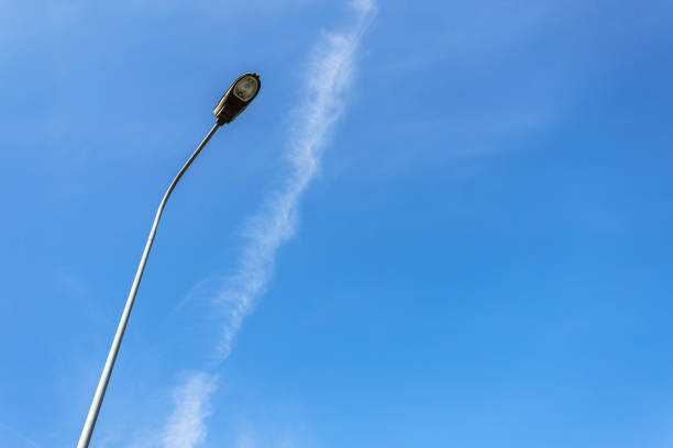 Bottom view of a street lamp on a background of blue sky in clear weather