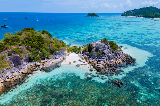 couple with a kayak on a small Island in front of the Island Ko Lipe Thailand couple with a kayak on a small Island in front of the Island of Ko Lipe Thailand, Kla Island satun province stock pictures, royalty-free photos & images