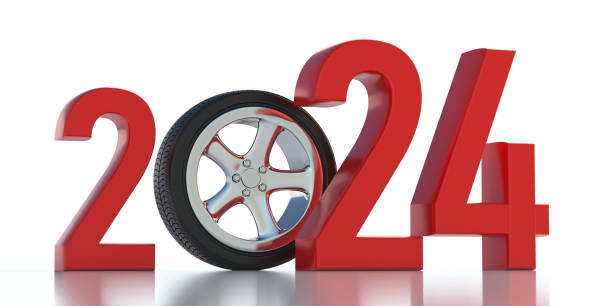 istock 2024 New Year, tire on alloy wheel between red digit isolated on white background. 3d render 1482995489
