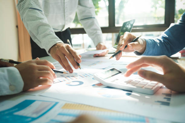 istock Businessmen working together at desk. 1482996725