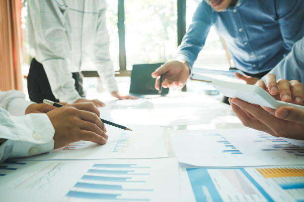 istock Businessmen working together at desk. 1482996732