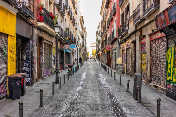 April 18, 2023: This photo captures the essence of a street in Madrid, Spain. The colorful buildings, atmosphere, and art create a lively scene that epitomizes the energy of the city. Whether you're looking to feature the city's vibrant lifestyle or highlight the beauty of its architecture, this photo is sure to add an authentic touch to any project.