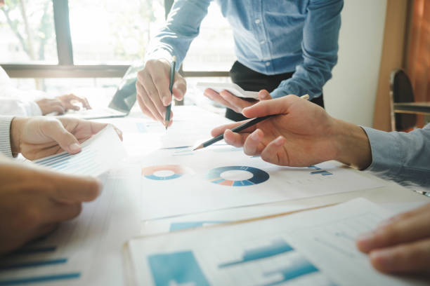 istock Businessmen working together at desk. 1482997169