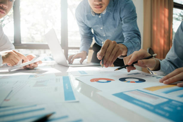 istock Businessmen working together at desk. 1482997170