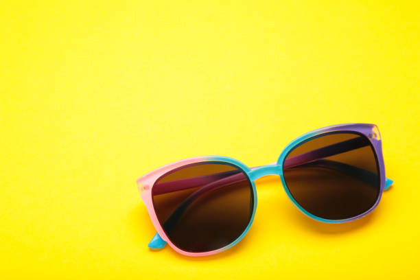 istock Colorful sunglasses on yellow background. Top view 1482998134