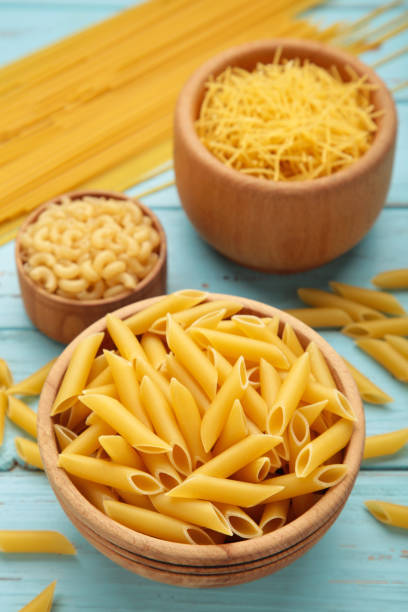 istock Various types of Italian pasta on blue background 1482998473