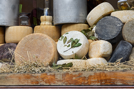 Typical food store, grocery with varieties of cheese, dairy products in Tuscany, Italy