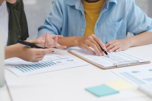 istock Close up business teamwork concept discussing graphs showing the results. 1482999253