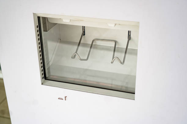 istock A side-view image showing a compartment for accepting drink cup lids and straws from a vending machine. 1483000073
