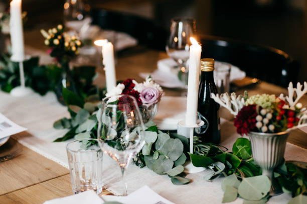 istock Table served for wedding party. Candles, decoration, cutlery and drinks on festive table. Wedding table decorated with flowers and candles. Table setting, selective focus 1483000516